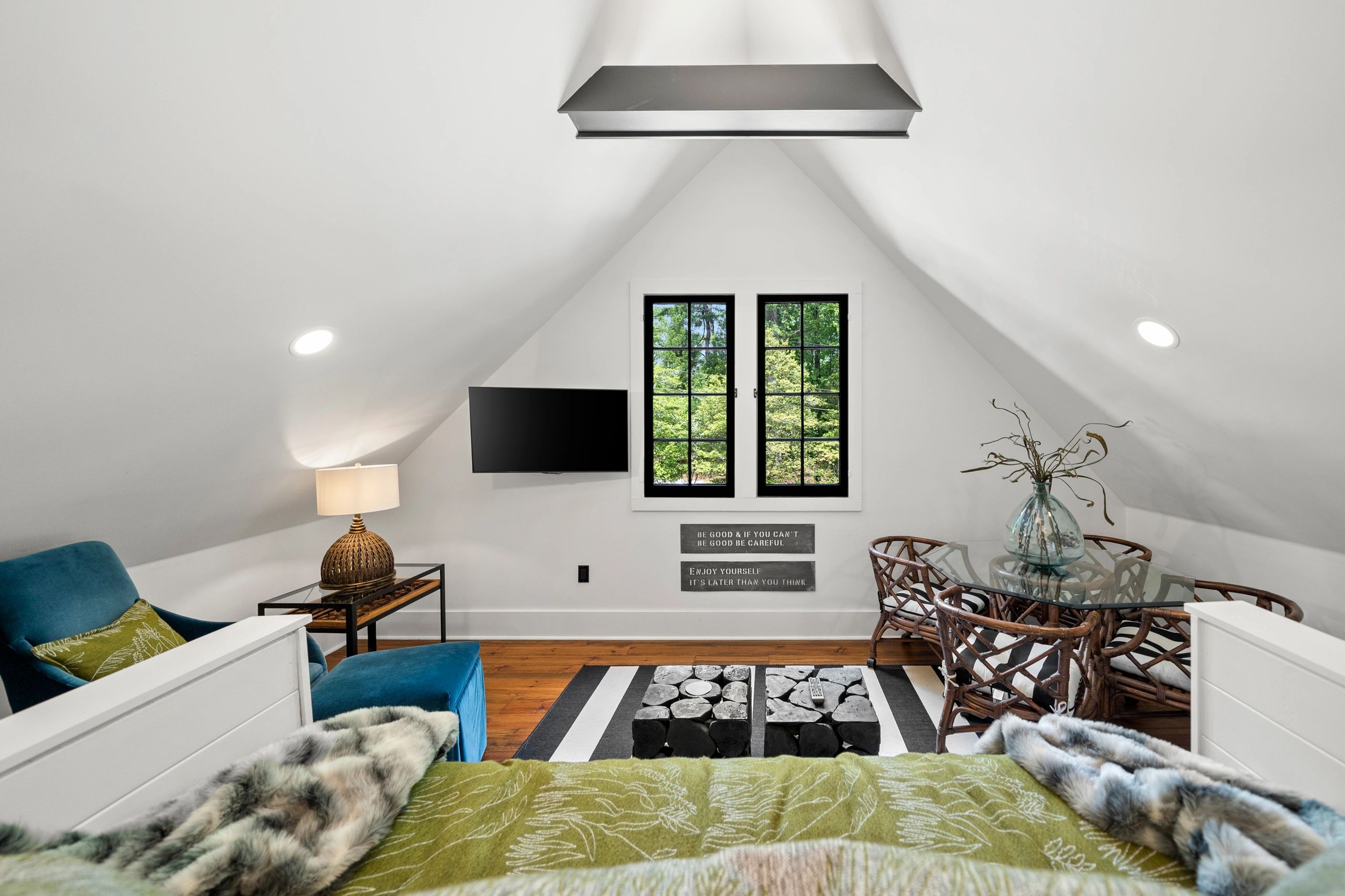 Cozy attic room with modern decor and large windows